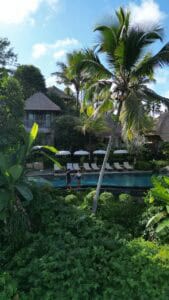 Pareja relajándose y disfrutando de su estancia en un lujoso hotel en Bali, Indonesia, rodeados de la belleza tropical y el ambiente único de la isla.